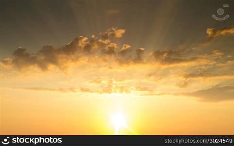 Blue and orange sunset sky with rays of sun. Natural landscape for background