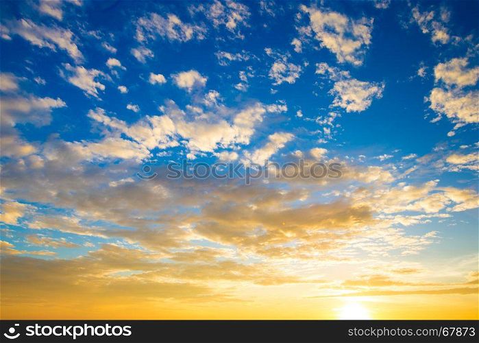 Blue and orange sunset sky with rays of sun. Natural landscape for background