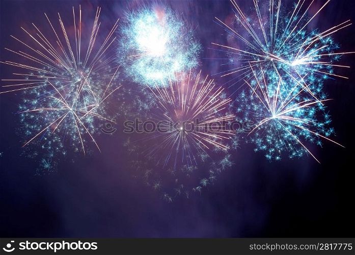 Blue and purple colorful fireworks on the black sky background. Holiday celebration.