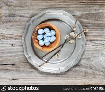 Blue and white Easter eggs and couple of sprigs of fluffy willow on the old pewter plate