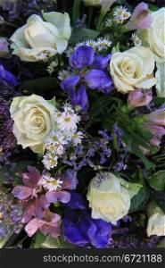 Blue and white flower arrangement with iiris and white roses