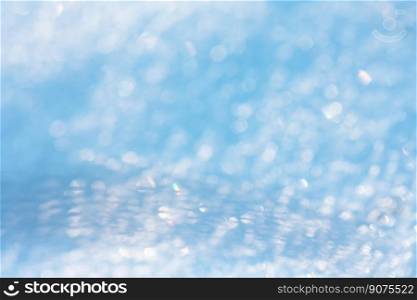 Blue and white snow bubble blurred background. Shining frozen snowy white christmas background. Blurred snow bokeh winter universal background. Blurred defocused background