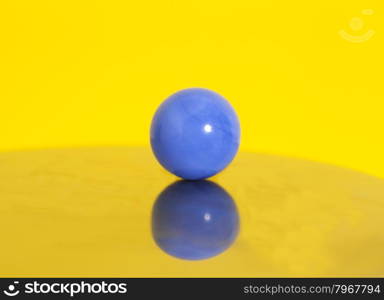 Blue ball on yellow background