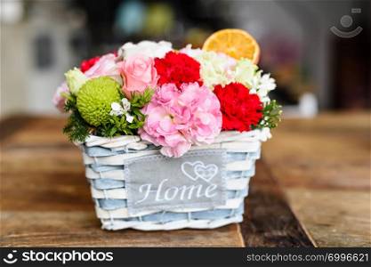 Blue basket with arranged flowers