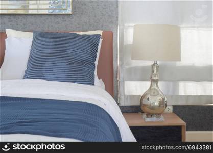 Blue bedding style and classic style white reading lamp in bedroom