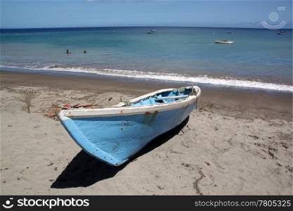 Blue boat on the sand beach in caribean island Grenada