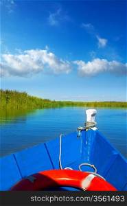 Blue boat sailing in Albufera lake of Valencia in a sunny blue sky day