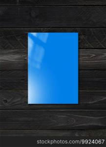 Blue booklet cover isolated on black wood background, mockup template. Blue Booklet cover template on black wood background