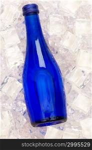 Blue bottle of water on ice cubes