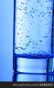 blue bubbled water in glass