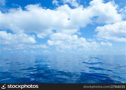 Blue calm sea water in offshore ocean with clouds mirror surface