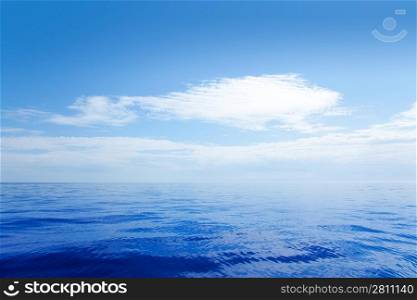 Blue calm sea water in offshore ocean with clouds mirror surface