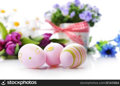 blue campanula flowers in flower pot and easter painted eggs