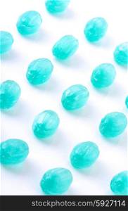 Blue candies on white background