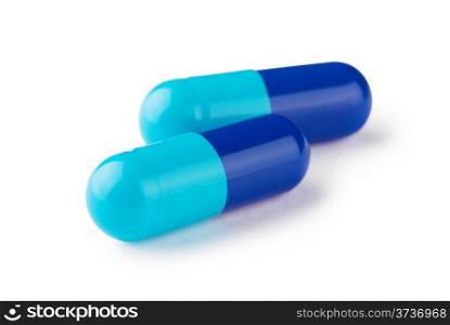Blue capsules with powder isolated on white background