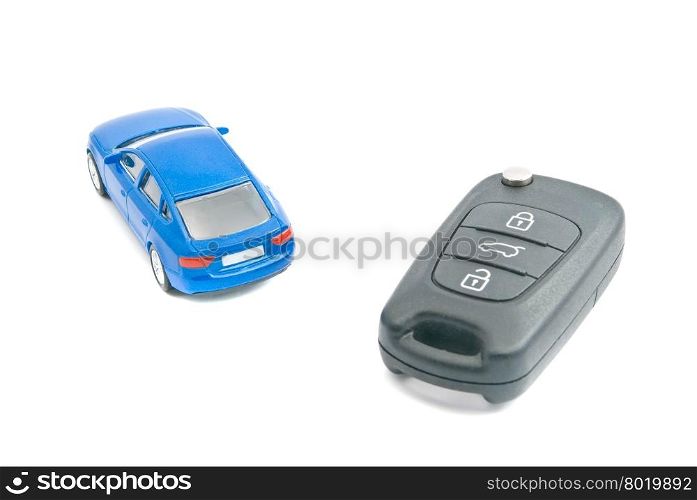 blue car and black car keys on white