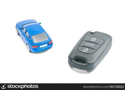 blue car and black car keys on white