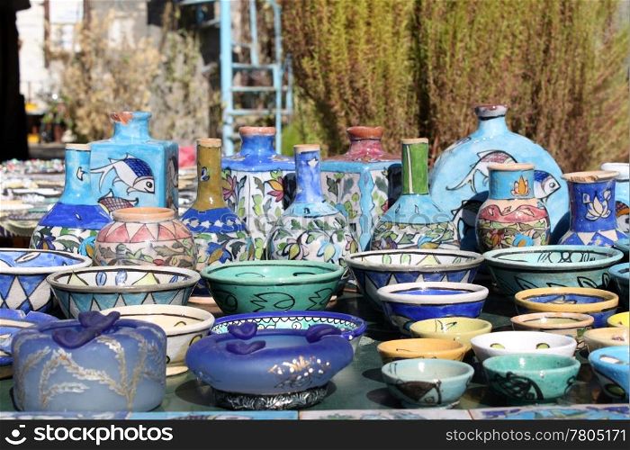 Blue ceramics on the table on the street of Bosra, Syria