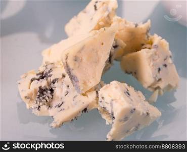 blue cheese on white isolated background. close up view
