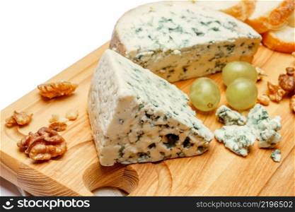 blue cheese on wooden cutting board. White background. blue cheese on wooden cutting board