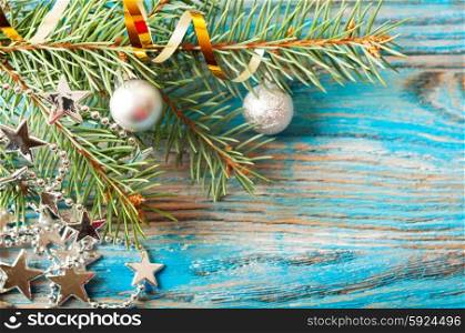 Blue Christmas background with silver decorations and fir branch