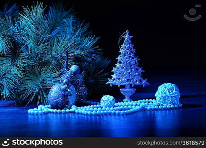 Blue Christmas collage. Ball and ribbon on a blue background.