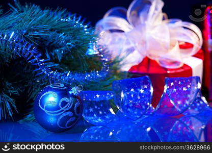 Blue Christmas collage. Ball and ribbon on a blue background.