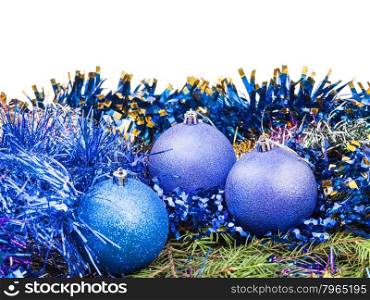 blue Christmas decorations on green spruce tree branch isolated on white background