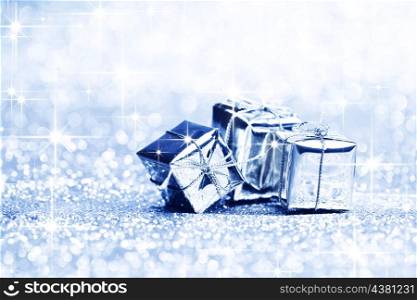 Blue christmas gifts on glitter shiny stars background