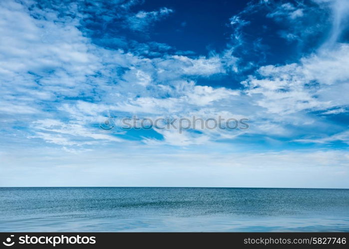 Blue clear sea and sky with white clouds