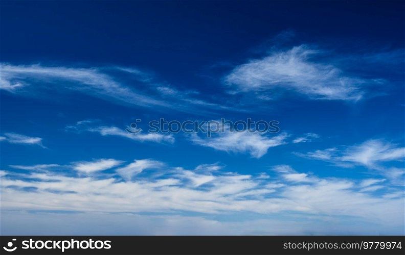 Blue clear sky with white cirrus spindrift clouds background. Blue clear sky with clouds