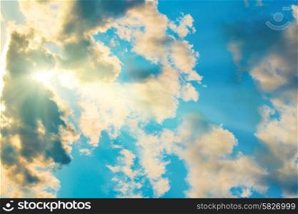 Blue clouds and sky. Natural background with sunbeams