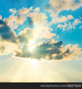 Blue clouds and sky. Natural background with sunbeams