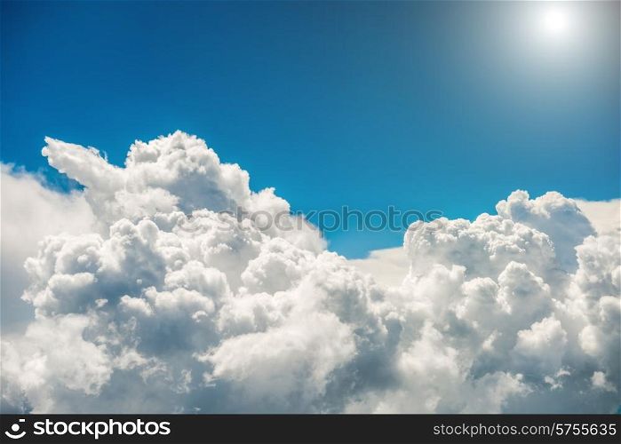 Blue clouds, bright sun and sky. Natural background