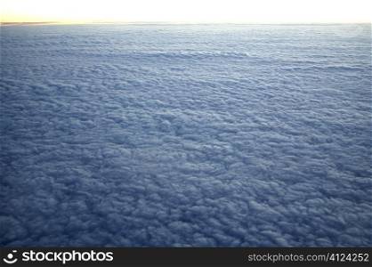 Blue cloudscape aerial view from aircraft as a land of sheeps clouds