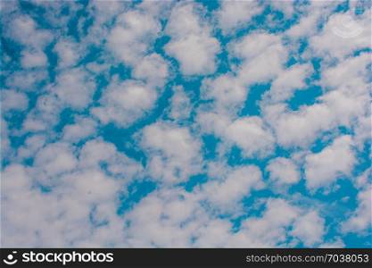 Blue cloudy sky with white and grey clouds