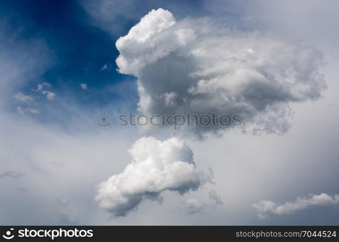 Blue cloudy sky with white and grey clouds