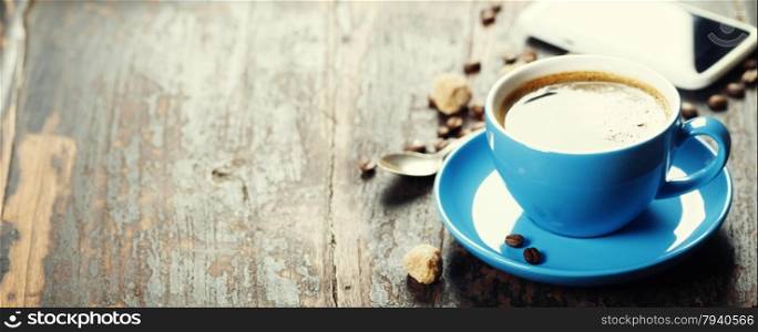 Blue coffee cup on vintage wooden background