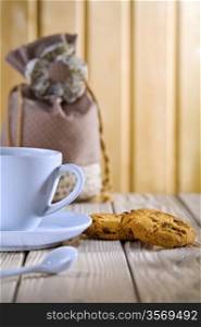 blue coffee cup with cookies and bag