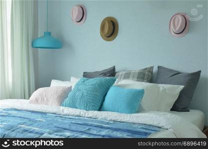 Blue color scheme teenager bedroom with hats on wall decoration