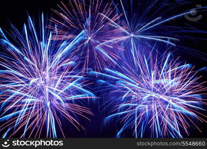 Blue colorful fireworks on the black sky background