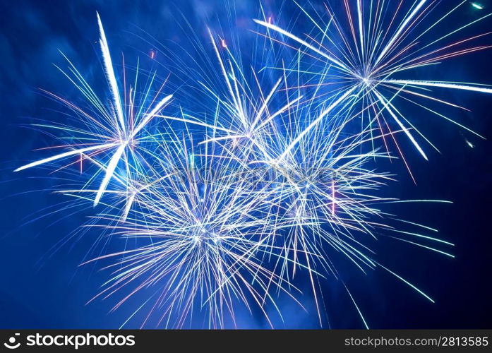 Blue colorful fireworks on the black sky background. Holiday celebration.