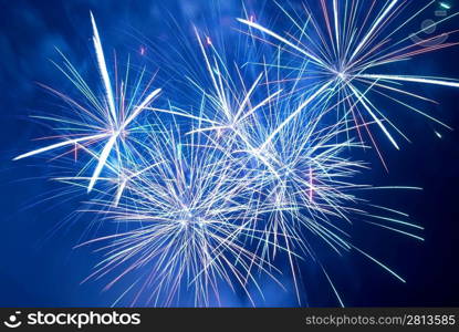 Blue colorful fireworks on the black sky background. Holiday celebration.