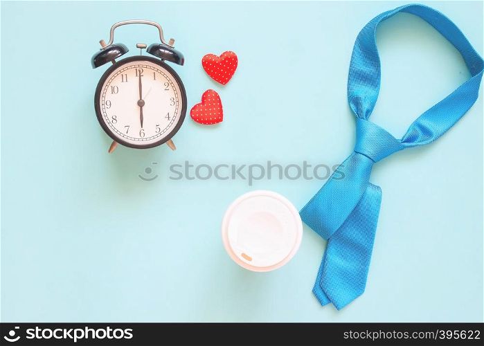 Blue colour necktie, coffee cup and clock on pastel background. Top view, Father's Day concept