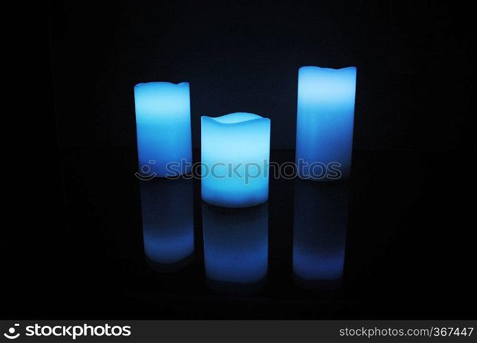 Blue colour wax scented candles with candle reflection. Blue colour wax scented candles with candle reflection.