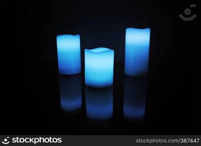 Blue colour wax scented candles with candle reflection. Blue colour wax scented candles with candle reflection.