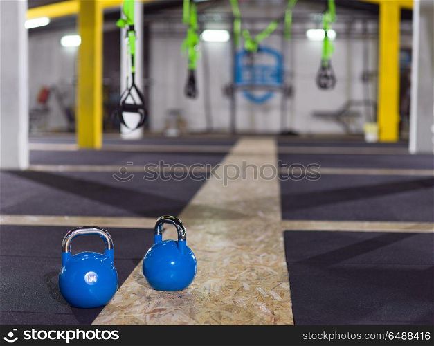 blue Crossfitness Kettlebells at fitness gym floor. blue Crossfitness Kettlebells