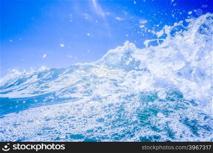 blue crystal water waves crashing on beach