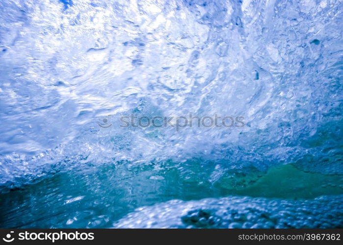 blue crystal water waves crashing on beach