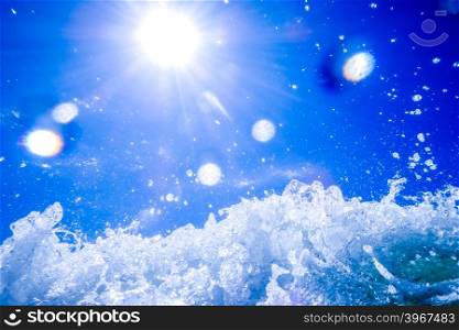 blue crystal water waves crashing on beach